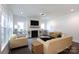 Inviting living room featuring a cozy fireplace and ample natural light from the windows at 5777 Stephanie St, Charlotte, NC 28212