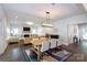 Open living space with dining area, showcasing a fireplace and contemporary design at 5777 Stephanie St, Charlotte, NC 28212