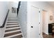 Elegant staircase with white risers, wood treads, and stylish wallpaper at 5777 Stephanie St, Charlotte, NC 28212