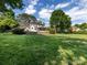 Expansive backyard view of a beautifully maintained lawn and the rear of the home at 5822 Alexa Rd, Charlotte, NC 28277