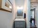 Elegant half bathroom featuring a marble countertop, framed mirror, stylish lighting, and neutral color scheme at 5822 Alexa Rd, Charlotte, NC 28277
