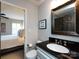 En-suite bathroom featuring a modern sink vanity, mirror, and view to the bedroom at 5822 Alexa Rd, Charlotte, NC 28277