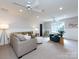 Spacious bonus room with couches, play furniture, ceiling fans and natural light at 5822 Alexa Rd, Charlotte, NC 28277