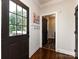 Inviting entryway with hardwood floors, wainscoting, and a view into the home's interior at 5822 Alexa Rd, Charlotte, NC 28277