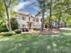 Beautiful painted brick two-story home with a manicured lawn and well-maintained landscaping, framed by mature trees and greenery at 5822 Alexa Rd, Charlotte, NC 28277