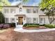 Stunning two-story painted brick home with a beautifully landscaped front yard and a striking, inviting double-door entryway at 5822 Alexa Rd, Charlotte, NC 28277