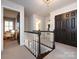 Second floor hallway with carpet, neutral paint, and dark-stained trim with a view into multiple rooms at 5822 Alexa Rd, Charlotte, NC 28277