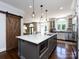 Modern kitchen with large island, pendant lighting, stainless steel appliances, and hardwood floors at 5822 Alexa Rd, Charlotte, NC 28277