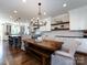Bright kitchen featuring white cabinets, subway tile backsplash, stainless steel appliances, and a wooden dining table at 5822 Alexa Rd, Charlotte, NC 28277