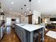 Open kitchen featuring a large island with marble countertops, pendant lighting, and hardwood floors at 5822 Alexa Rd, Charlotte, NC 28277