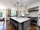 Spacious kitchen with a large center island, pendant lighting, and stainless steel appliances at 5822 Alexa Rd, Charlotte, NC 28277