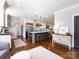 Modern kitchen with stainless steel appliances, large island, hardwood floors, and ample counter space at 5822 Alexa Rd, Charlotte, NC 28277