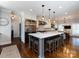 Open kitchen with island seating, stainless steel appliances, and adjacent dining area at 5822 Alexa Rd, Charlotte, NC 28277