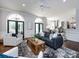 Inviting living room featuring hardwood floors, fireplace, comfortable seating, and access to the kitchen at 5822 Alexa Rd, Charlotte, NC 28277
