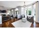 Comfortable seating area with fireplace, hardwood floors, large windows, and neutral decor at 5822 Alexa Rd, Charlotte, NC 28277