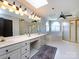 Bright bathroom with double vanity, skylights, a garden tub, and a glass-enclosed shower at 5822 Alexa Rd, Charlotte, NC 28277