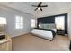 Spacious main bedroom with a tray ceiling, plantation shutters, and a dark accent wall at 5822 Alexa Rd, Charlotte, NC 28277