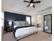 Large main bedroom features neutral carpet, tray ceilings, a dark accent wall and large windows at 5822 Alexa Rd, Charlotte, NC 28277