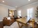 Office space featuring a wooden desk, comfortable armchairs, and natural light from the window and french doors at 5822 Alexa Rd, Charlotte, NC 28277