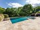 Enjoy this backyard pool surrounded by an expansive patio and lush landscaping at 5822 Alexa Rd, Charlotte, NC 28277