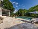 Enjoy a day outside at this backyard pool featuring a hot tub and space for outdoor seating at 5822 Alexa Rd, Charlotte, NC 28277