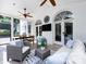 Bright sunroom with white brick, multiple ceiling fans, and plenty of comfortable seating at 5822 Alexa Rd, Charlotte, NC 28277