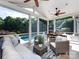 This screened-in porch is furnished with a seating area overlooking the pool and backyard at 5822 Alexa Rd, Charlotte, NC 28277