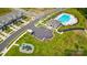 Aerial view showcasing the community pool, playground, parking, and streetscape at 6256 Culbert St # 187, Harrisburg, NC 28075
