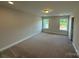Large carpeted room with neutral paint, recessed lighting, and two large windows at 6256 Culbert St # 187, Harrisburg, NC 28075