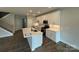 Modern kitchen features stainless steel appliances, an island with a sink and white cabinets at 6256 Culbert St # 187, Harrisburg, NC 28075