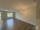 Spacious living room featuring hardwood floors, modern lighting, and ample natural light at 6256 Culbert St # 187, Harrisburg, NC 28075