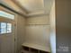 Functional mudroom featuring coat hooks, bench seating, and storage shelves near the entryway at 6256 Culbert St # 187, Harrisburg, NC 28075