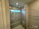 Bathroom with large glass-enclosed tiled shower, built-in bench and accent window at 6256 Culbert St # 187, Harrisburg, NC 28075