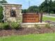 Community entrance sign with stone base and manicured landscaping welcomes you to Harrisburg Village at 6256 Culbert St # 187, Harrisburg, NC 28075