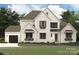 Charming two-story home with a white brick facade, well-manicured lawn and a welcoming entrance at 6274 Chimney Bluff Rd, Lancaster, SC 29720