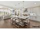 Open-concept kitchen with a large island, pendant lights, flowing into the living room and dining area at 6274 Chimney Bluff Rd, Lancaster, SC 29720
