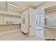 Bright walk-in closet featuring custom white shelving and storage adjacent to an ensuite bathroom with glass enclosed shower at 6274 Chimney Bluff Rd, Lancaster, SC 29720