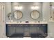 Bathroom showcasing dual vanities with modern round mirrors, stylish lighting, and sleek countertops at 8221 Houser St, Cornelius, NC 28031