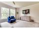 Spacious bedroom featuring a comfortable sitting area, dresser and large windows for relaxing and enjoying the view at 8221 Houser St, Cornelius, NC 28031