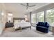 Bright and open bedroom featuring many windows and a nice sitting area to relax and unwind at 8221 Houser St, Cornelius, NC 28031