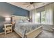 Cozy bedroom with blue accents, a comfortable bed, ample natural light, and side tables at 8221 Houser St, Cornelius, NC 28031