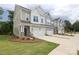 Shot of modern townhomes with well-maintained lawns and attached garages on a cloudy day at 8221 Houser St, Cornelius, NC 28031