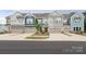 Image of craftsman style townhomes with attached garages, landscaping, and curb appeal at 8221 Houser St, Cornelius, NC 28031