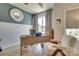 Inviting home office featuring a wood desk, neutral tones, ample natural light, and cozy seating area at 8221 Houser St, Cornelius, NC 28031