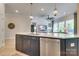 Spacious kitchen island featuring a sink, modern appliances, and a great view of the living space at 8221 Houser St, Cornelius, NC 28031