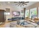 Bright living room features stylish furnishings, large windows, and a ceiling fan at 8221 Houser St, Cornelius, NC 28031