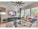 Bright living room with a large TV, comfortable seating, and serene views from the large windows at 8221 Houser St, Cornelius, NC 28031