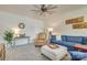 Comfortable living room featuring a plush blue couch, cozy seating, modern decor, and ample natural light at 8221 Houser St, Cornelius, NC 28031