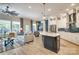 Open-concept living room with stainless steel appliances, blue island, and light wood flooring at 8221 Houser St, Cornelius, NC 28031