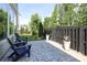 Charming patio with stone pavers, Adirondack chairs, and a fenced yard at 8221 Houser St, Cornelius, NC 28031